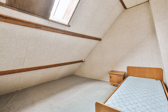 Empty cozy bed in small attic room