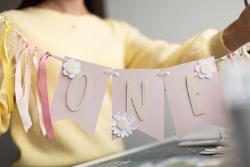 Preparing a Celebratory Banner with 'ONE' Inscription