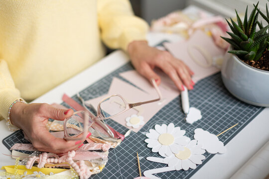 Crafting enthusiast working with paper and decorations