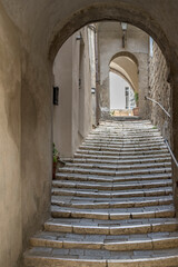 flight of steps in narrow uphill lane at medieval hilltop village, Pitigliano, Italy - obrazy, fototapety, plakaty