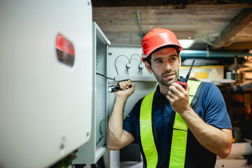 Technician Engineering setting inverter solar panel in electrical room. Service engineer installing...