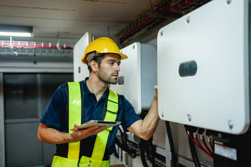 Technician Engineering setting inverter solar panel in electrical room. Service engineer installing...