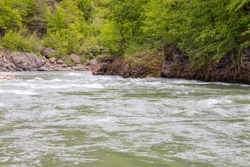 Mountain river spring season with sand and stone shoals along the banks.