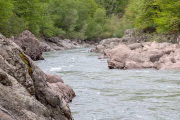 Naklejka na ściany i meble Mountain river spring season with sand and stone shoals along the banks.
