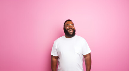 Plus size male model. Happy bearded man wearing white shirt over pink background with charming cute smile. 