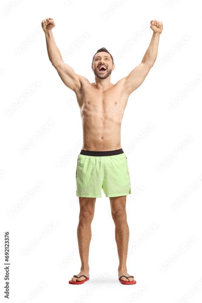 Poster young man in swimming shorts gesturing happiness