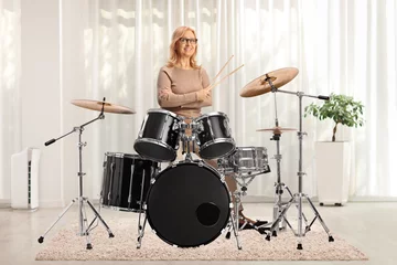 Fotobehang Mature female drummer posing with a drum set © Ljupco Smokovski