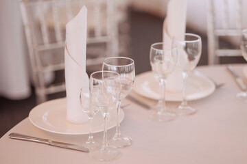 Three empty glasses for alcoholic beverages of vodka, wine and champagne are on the table. High quality photo