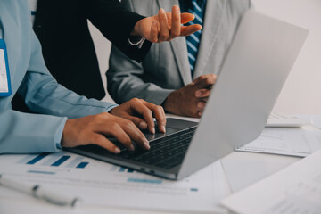 Financial analysts analyze business financial reports on a digital tablet planning investment...