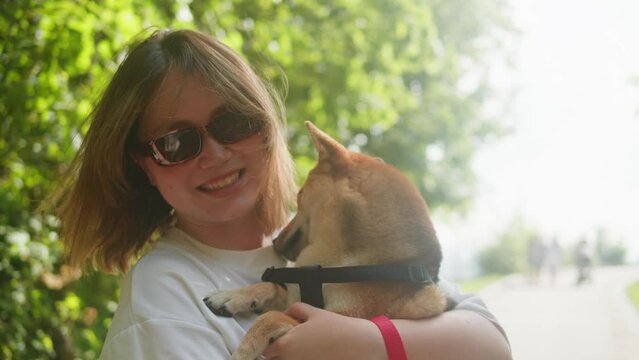 Portrait of pretty young woman with shiba inu in the pak. Japan dog with owner. shiba inu, hachiko, japanese dog, puppy in nature, dog true friend