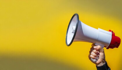 megaphone in hand on a yellow background panoramic image attention concept announcement