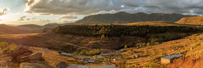 Panorama of Daliwe village in the Lesotho mountains at golden hour, Africa - obrazy, fototapety, plakaty