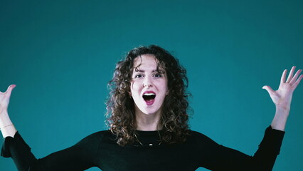 Playful Female Acting Out Mind-Blowing Idea on teal background, Shocked with Enlightened Amusement,...