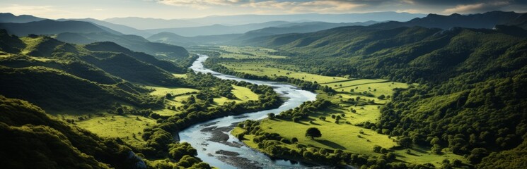 A winding river flows through green fields and pastures. Beautiful view from a drone. Landscape with open space. Banner with copy space