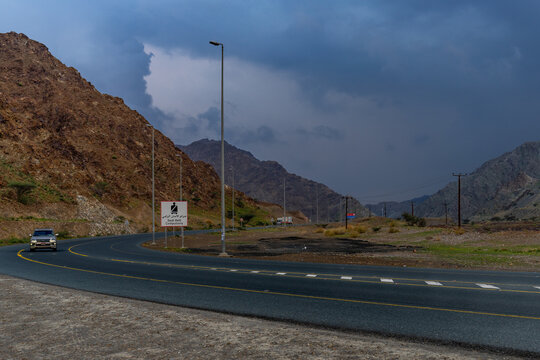 Fujairah Drive: A Car Adventure with Masafi Mountains in the Background Highway Views: Scenic Drive Behind the Majestic Masafi Mountains