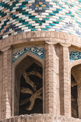 An ancient minaret of a brick mosque faced with ceramic tiles and mosaics in the ancient city of...