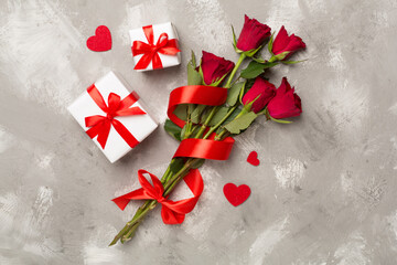 Red rose flowers with gift box on concrete background, top, view. Valentine's day concept