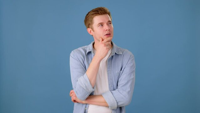 Thoughtful man scratching head while remembering something