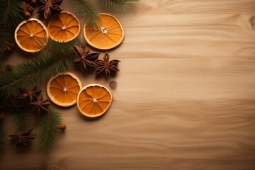 Obraz na płótnie Canvas Light background, slightly visible wooden floor, fir branch, cinnamon, candy and dried orange circle
