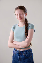Studio Portrait Of Happy Smiling And Confident Teenage Girl Looking At Camera