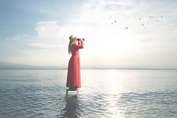 surreal woman in the middle of the sea on a stool observes her infinity with the telescope,...