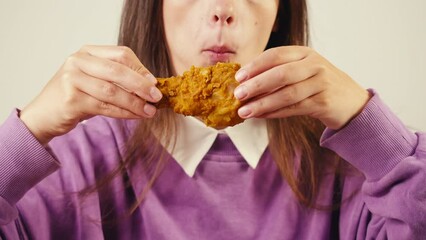 Young woman eating chicken fat leg and burger student eat junk food delivery close up.