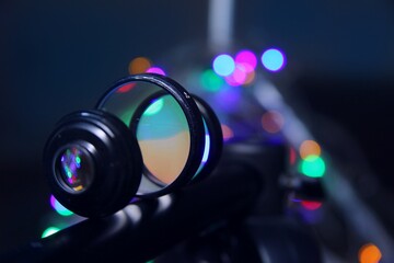 beautiful close background of a device with lenses in a row. Lenses refract light of different...