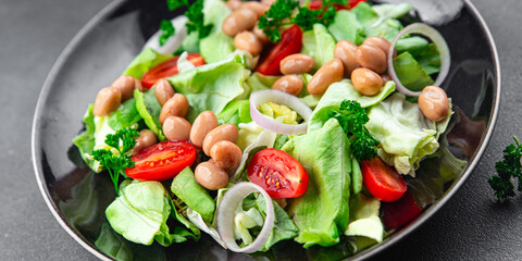 white bean salad green lettuce, tomato, onion healthy eating appetizer meal food snack on the table copy space food background rustic top view