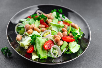 white bean salad green lettuce, tomato, onion healthy eating appetizer meal food snack on the table copy space food background rustic top view
