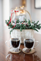 Wicker basket with Christmas gift set with two cups of coffee on the table