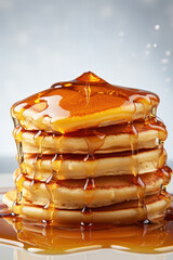 Fototapeta na wymiar Close-up of delicious pancakes with maple syrup on a light background. Food photography. Pancake day