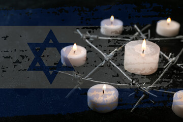 Burning candles and barbed wire in shape of David star on black background. International Holocaust...