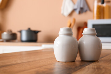 Salt shakers on wooden kitchen counter