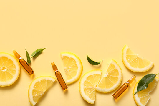 Ampoules with vitamin C and lemon slices on yellow background