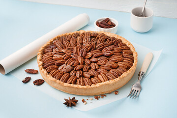 Tasty pecan pie on blue background