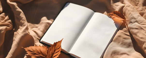 Blank open notebook mockup with empty sheets, brown fall leaves on terracotta knitted fabric background with natural sunlight shadows. Lifestyle aesthetic business brand or writer blog template  - obrazy, fototapety, plakaty
