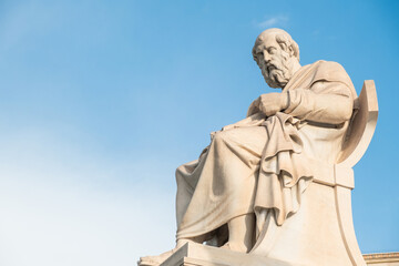Statue of Plato from the Academy of Athens, Greece against blue sky. Popular Greek landmark and...