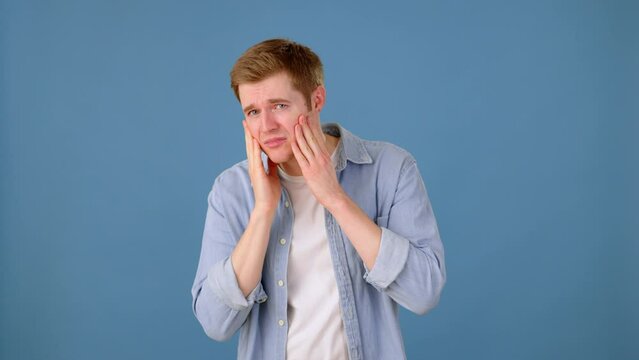 Guy touching face and feeling disatisfied with appearance