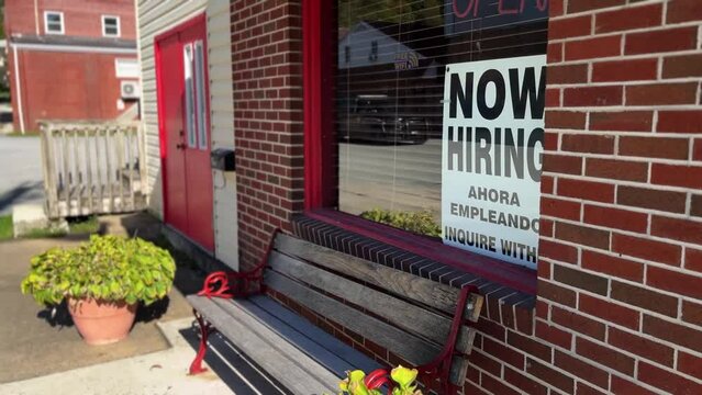 Now Hiring, Help Wanted sign on Mexican restaurant window by side of a rural West Virginia road in summer.