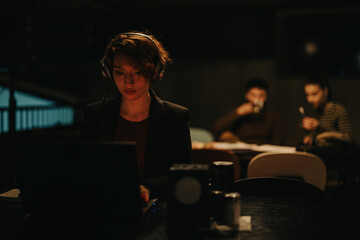 Businesswoman analyzing sales statistics and coordinating a project in a late-night corporate...