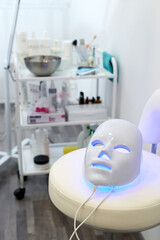 Led light therapy facial mask. Home skincare and me time concept. Light rejuvenating mask for facial skin therapy.