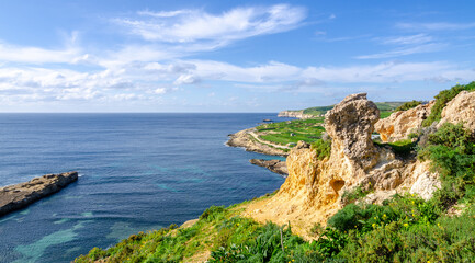 Mgarr, Malta - Panorama of Xatt l-Aħmar bay and cliffs in Malta at with beautiful colorful sky and...