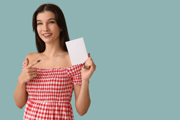 Woman with voting paper on light blue background