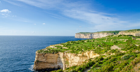 Rocky limestone coastline of Gozo island and Mediterranean Sea with turquoise blue water and...