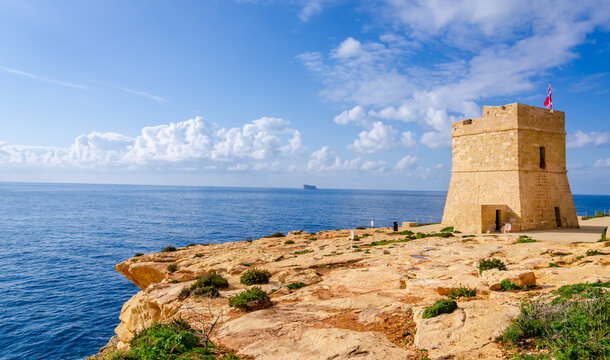 Torri Xutu. Ancient watch tower near Blue Grotto of Malta with Filfla island in a background.