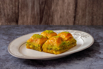 Pistachio Turkish baklava on a white plate.Traditional delicious Turkish baklava