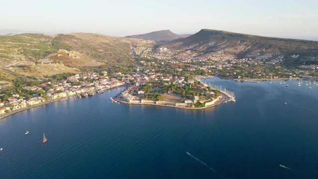 Aerial wide shot of Foca resort town with touristic street on sea bay, Izmir region Turkey