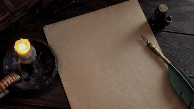 Vintage paper with a quill pen and an old candle burning. Mockup of text writing