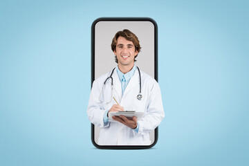 Positive male doctor therapist in white coat using tablet, on big phone screen, isolated on blue background, studio