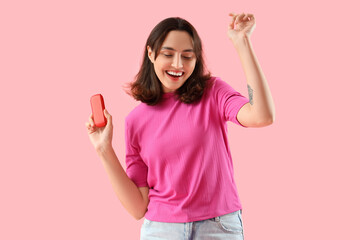 Young woman with block of electronic cigar on pink background